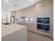 Stylish kitchen featuring modern cabinets, stainless steel appliances, quartz countertops, and tile backsplash at 17013 Alpenhorn Ct, Punta Gorda, FL 33955