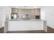 Modern kitchen with sleek cabinets, quartz countertops, stainless steel appliances, and open layout at 17013 Alpenhorn Ct, Punta Gorda, FL 33955