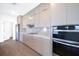 Contemporary kitchen with light gray cabinets, stainless steel appliances, and quartz countertops with a tile backsplash at 17013 Alpenhorn Ct, Punta Gorda, FL 33955