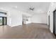 Bright, open-concept living space with light wood floors, featuring a modern kitchen in the background at 17013 Alpenhorn Ct, Punta Gorda, FL 33955