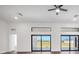 Bright living room with large windows, modern ceiling fan, and dark wood floors offering scenic views at 17013 Alpenhorn Ct, Punta Gorda, FL 33955