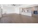 Open floor plan with light wood floors, modern kitchen with stainless steel appliances, and ample natural light at 17013 Alpenhorn Ct, Punta Gorda, FL 33955