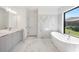 Luxurious bathroom with soaking tub, walk-in shower, and double vanity at 17261 Naiad Ct, Punta Gorda, FL 33955