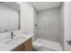 Bathroom with a wood vanity and marble tile walk-in shower with modern fixtures at 17261 Naiad Ct, Punta Gorda, FL 33955