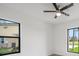 Bright room with black framed windows, and a modern ceiling fan for comfortable living at 17261 Naiad Ct, Punta Gorda, FL 33955