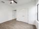 A bright bedroom features black ceiling fan and wood-look tile flooring at 17261 Naiad Ct, Punta Gorda, FL 33955