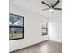 Bright bedroom features black framed windows and wood-look floors for a stylish look at 17261 Naiad Ct, Punta Gorda, FL 33955