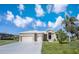 Beautiful home with a well-manicured lawn and three-car garage at 17261 Naiad Ct, Punta Gorda, FL 33955