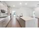 Modern kitchen with sleek gray cabinets, large island, and stainless steel appliances at 17261 Naiad Ct, Punta Gorda, FL 33955