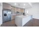 Bright kitchen featuring stainless steel refrigerator, center island, and modern cabinets at 17261 Naiad Ct, Punta Gorda, FL 33955