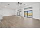Spacious living room with expansive windows offering abundant natural light and wood flooring at 17261 Naiad Ct, Punta Gorda, FL 33955