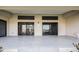 Covered patio with sliding glass doors, black trim windows, and speckled concrete at 17261 Naiad Ct, Punta Gorda, FL 33955