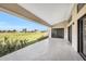 Spacious covered patio that overlooks an expansive green space and neighboring houses at 17261 Naiad Ct, Punta Gorda, FL 33955