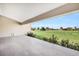 Covered patio overlooking a large grassy space with neighboring houses in the distance at 17261 Naiad Ct, Punta Gorda, FL 33955