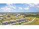 Aerial view of condo community featuring lush landscaping, ponds, and serene views at 17288 Acapulco Rd # 411, Punta Gorda, FL 33955