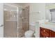 Bathroom features a tiled walk-in shower with frameless glass doors at 17288 Acapulco Rd # 411, Punta Gorda, FL 33955