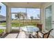 Screened lanai featuring tile flooring, comfortable seating, and a serene backyard view at 17288 Acapulco Rd # 411, Punta Gorda, FL 33955