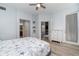 Light-filled main bedroom with a beach theme, ceiling fan, closet, ensuite bathroom, and access to lanai at 17288 Acapulco Rd # 411, Punta Gorda, FL 33955