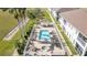 Aerial view of a community pool with plenty of lounge chairs surrounded by well maintained landscaping at 17288 Acapulco Rd # 411, Punta Gorda, FL 33955