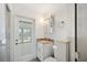 Bathroom with white vanity, granite countertop and door to the patio at 1756 Boca Raton Ct, Punta Gorda, FL 33950