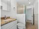 Bathroom featuring a shower with glass door, white vanity, and granite countertop at 1756 Boca Raton Ct, Punta Gorda, FL 33950