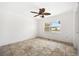 Cozy bedroom featuring tiled floors, a ceiling fan, and natural light at 1756 Boca Raton Ct, Punta Gorda, FL 33950