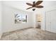 Bright bedroom with tiled floors, ceiling fan, and ensuite bathroom at 1756 Boca Raton Ct, Punta Gorda, FL 33950
