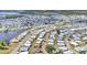 Expansive aerial perspective of a dense residential area bordering waterways, showcasing a vibrant community layout at 215 Schooner St, North Port, FL 34287