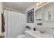 Bathroom featuring a toilet, vanity with white sink, and shower with a white curtain at 215 Schooner St, North Port, FL 34287
