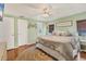 Comfortable bedroom with soothing colors, wood floors, ceiling fan, and ample natural light at 215 Schooner St, North Port, FL 34287