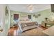 Comfortable bedroom with soothing colors, wood floors, ceiling fan, and ample natural light at 215 Schooner St, North Port, FL 34287