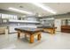 Recreation area with billiards tables, kitchenette, and seating for leisure and socializing at 215 Schooner St, North Port, FL 34287