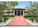 Clubhouse entrance with manicured landscaping and red-paved sidewalk, great place to meet with neighbors at 215 Schooner St, North Port, FL 34287