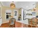 Inviting dining area adjacent to the kitchen with a glass table, rattan chairs, and ample natural light, great for meals at 215 Schooner St, North Port, FL 34287