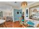 Charming dining area with glass table, rattan chairs and modern decor in an open floor plan at 215 Schooner St, North Port, FL 34287