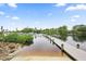 Scenic dock with lush greenery along the water, perfect for boating and enjoying waterfront views at 215 Schooner St, North Port, FL 34287
