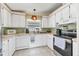 Well-equipped kitchen with ample white cabinetry and appliances, offering functionality for meal preparation and storage at 215 Schooner St, North Port, FL 34287