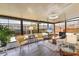 Bright sunroom with large windows, comfortable seating, and a view of the outdoors at 215 Schooner St, North Port, FL 34287