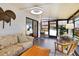 Bright sunroom with large windows, comfortable seating, and a view of the outdoors at 215 Schooner St, North Port, FL 34287