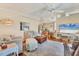 Bright and airy living room with neutral decor, a comfortable seating arrangement, and a view into the dining area at 215 Schooner St, North Port, FL 34287