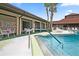 Community pool area with comfortable seating, palm trees, and clear blue water for relaxation at 215 Schooner St, North Port, FL 34287