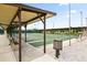 Outdoor shuffleboard courts with shaded seating offer an active lifestyle in this inviting community at 215 Schooner St, North Port, FL 34287