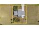 Aerial view of house on a large lot with a spacious yard and long driveway at 25413 Prada Dr, Punta Gorda, FL 33955