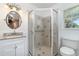 Clean bathroom featuring a glass door shower, vanity, and white toilet at 25413 Prada Dr, Punta Gorda, FL 33955