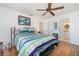 Comfortable bedroom with wood floors, ceiling fan, and a connecting bathroom at 25413 Prada Dr, Punta Gorda, FL 33955