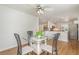 Open dining area featuring a glass table, modern light fixture, and seamless connection to the kitchen at 25413 Prada Dr, Punta Gorda, FL 33955