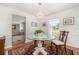 Elegant dining room boasting a glass table, decorative chandelier, and stylish decor at 25413 Prada Dr, Punta Gorda, FL 33955