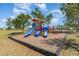 Community playground with slides, climbing structures, and swing set at 25413 Prada Dr, Punta Gorda, FL 33955