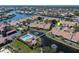 Aerial view of waterfront condos featuring a pool and pond with bridge in a beautiful, manicured neighborhood at 2645 W Marion Ave # 114, Punta Gorda, FL 33950