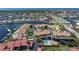 Aerial view of waterfront condos, adjacent to the marina, featuring a pool and landscaping at 2645 W Marion Ave # 114, Punta Gorda, FL 33950